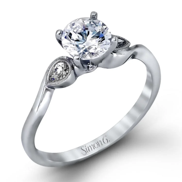 Women’s gemstone halo engagement rings-This charming white gold engagement ring and band are set with .12 ctw of pear shaped diamonds in lovely teardrop settings. The band mirrors the shape of the engagement ring so that they fit together perfectly.